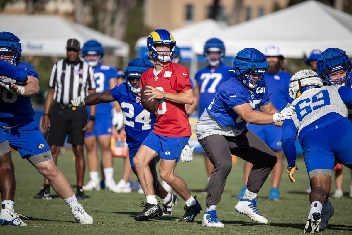 Rams quarterback Stetson Bennett rolls out of the pocket for a pass during practice.