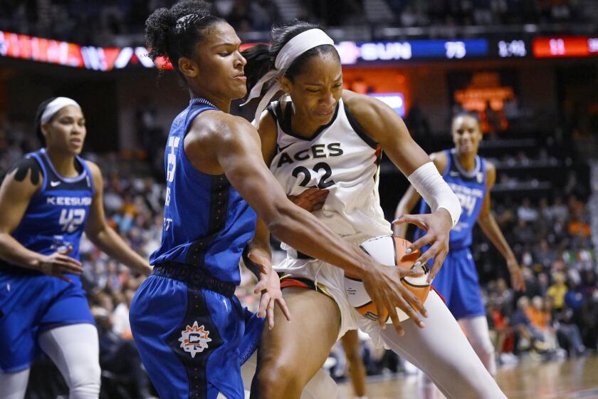 Connecticut Sun's Alyssa Thomas, front left, knocks the ball from Las Vegas Aces' A'ja Wilson (22) during the second half in Game 3 of a WNBA basketball final playoff series, Thursday, Sept. 15, 2022, in Uncasville, Conn. (AP Photo/Jessica Hill)