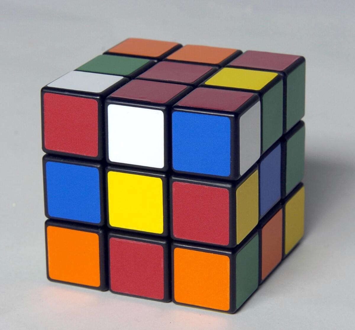 You can use a Rubik's Cube to explain symmetry groups: Every rotation of the cube is a "symmetry," and these combine into what mathematicians call a group.