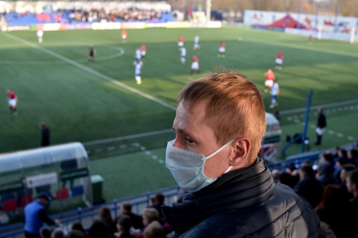 TOPSHOT - A supporter of FC Minsk, wears a facemask for protective measures amid concerns over the spread of the COVID-19, as he attends the Belarus Championship football match between FC Minsk and FC Dinamo-Minsk in Minsk, on March 28, 2020. - Belarus continue its championship despite all the leagues in Europe cancelled it to curb the spread of the COVID-19, the novel coronavirus. (Photo by Sergei GAPON / AFP) (Photo by SERGEI GAPON/AFP via Getty Images)