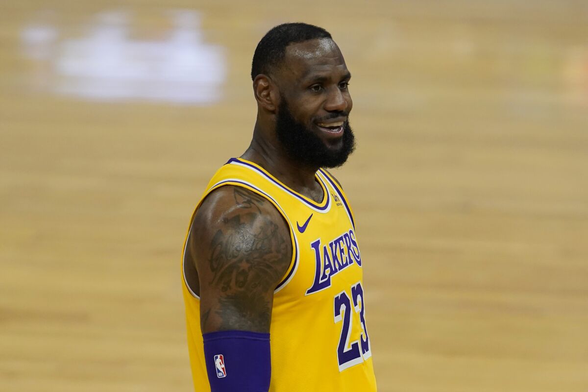 Lakers forward LeBron James smiles during a game against the Golden State Warriors.