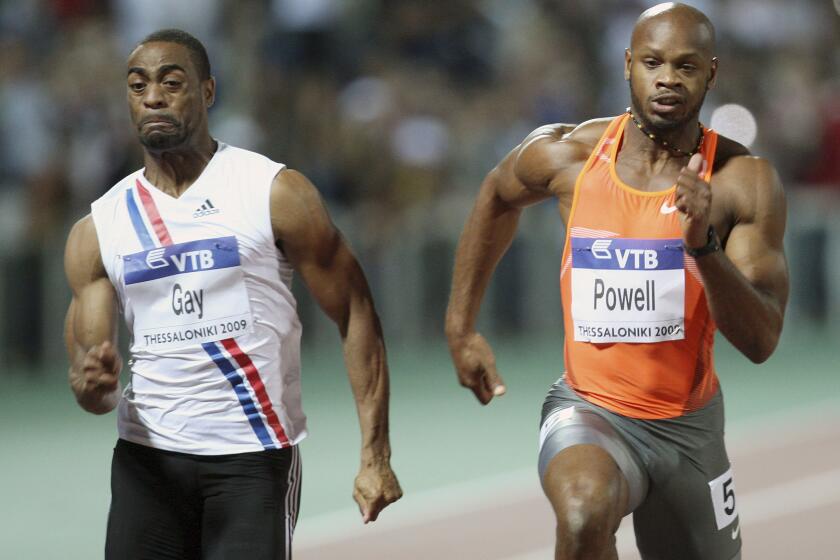 Tyson Gay, left, of the United States and Asafa Powell of Jamaica compete in the men's 100-meter race during an IAAF World Athletics Final on Sept. 12, 2009.