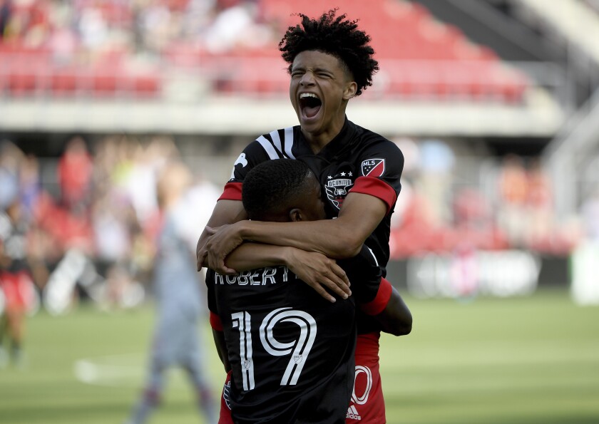 D.C. United's Kevin Paredes, rear, celebrates with Nigel Robertha after Robertha scored against Toronto FC during the first half of an MLS soccer match Saturday, July 3, 2021, in Washington. (Will Newton/The Washington Post via AP)