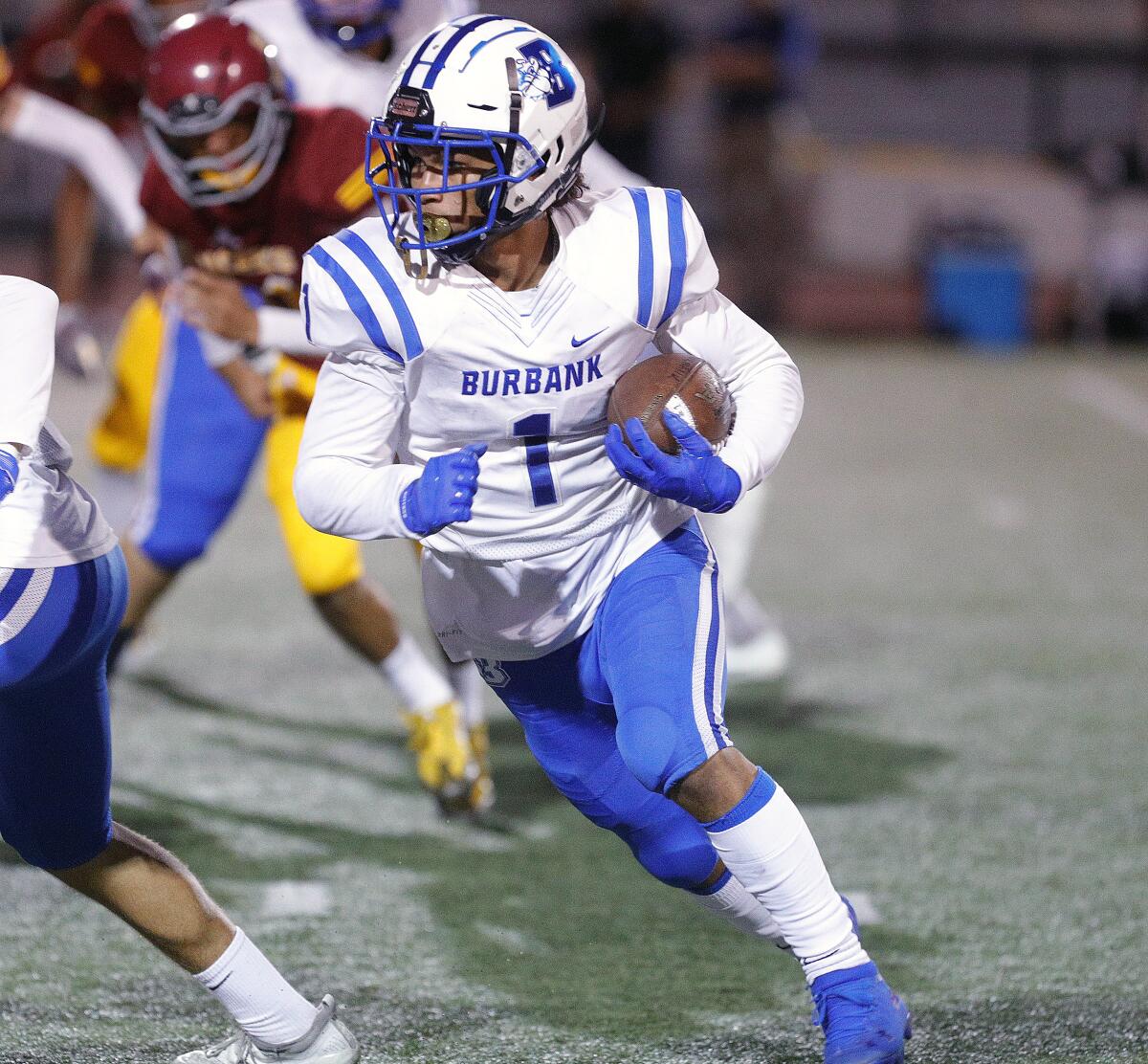 Burbank's Isaac Glover carries the ball on a first quarter run against Arcadia in a Pacific League football opener at Arcadia High School on Thursday, September 19, 2019.