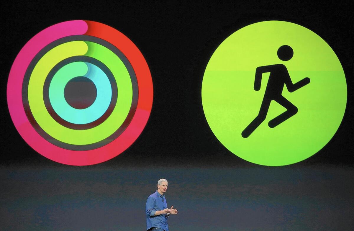 Apple CEO Tim Cook announces fitness apps for the new iPhone 6 and Apple Watch during an event in September 2014.