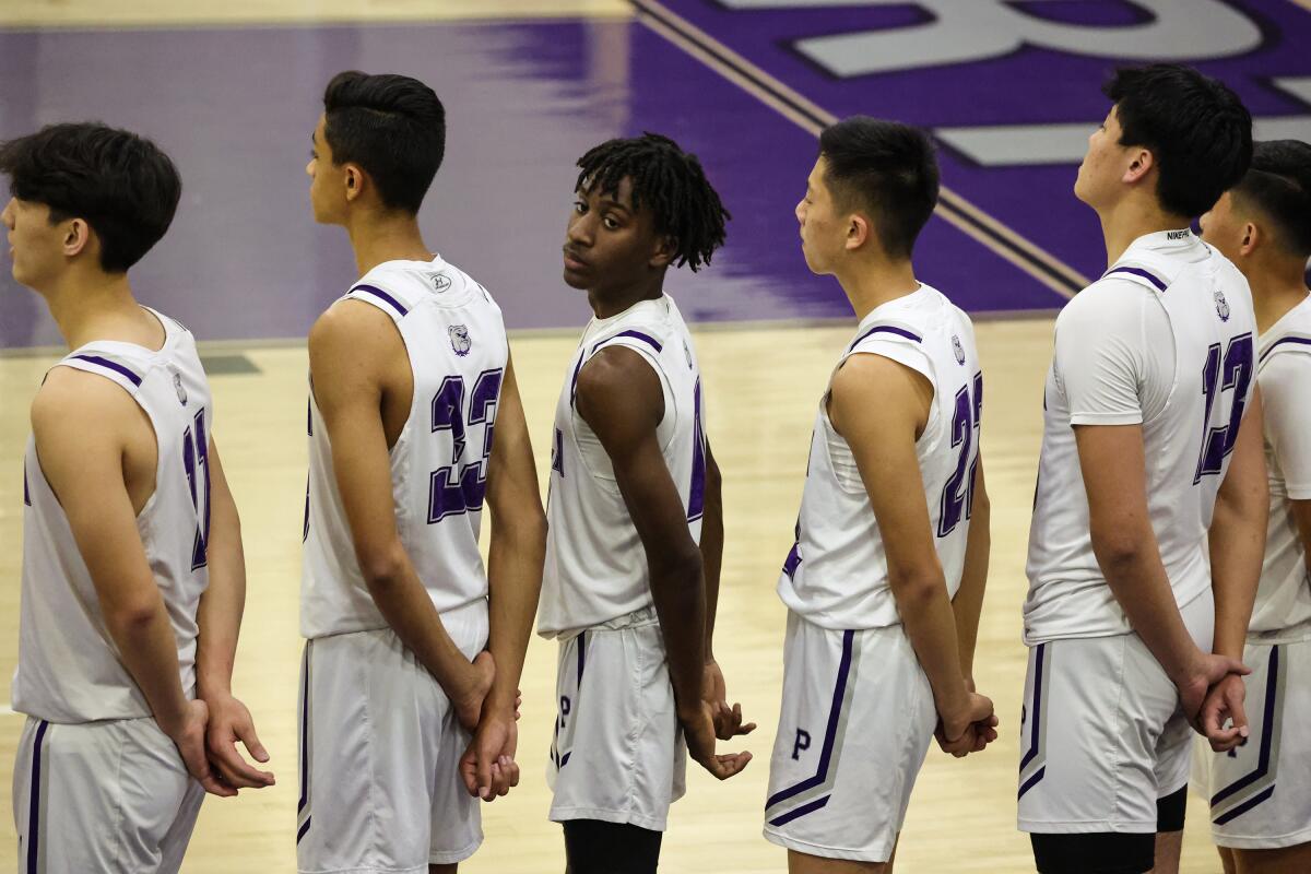 Makai Brown, third from left, a senior at Portola High School, plays in a basketball game against Irvine High School.