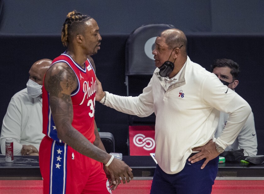 76ers coach Doc Rivers pats Dwight Howard on the shoulder after Howard was ejected March 27, 2021.