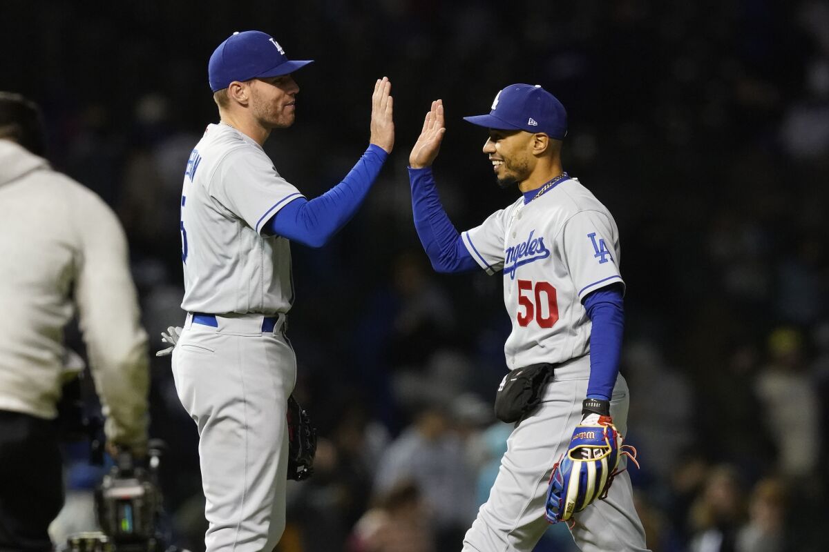 Dodgers first baseman Freddie Freeman, left, and right fielder Mookie Betts celebrate the team's 6-2 win over the Cubs