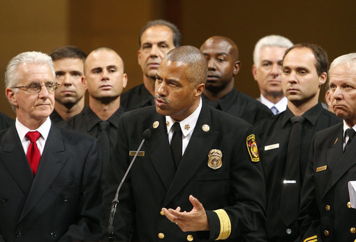 Fire Chief Brian Cummings, center, speaking Tuesday at City Hall in downtown Los Angeles.