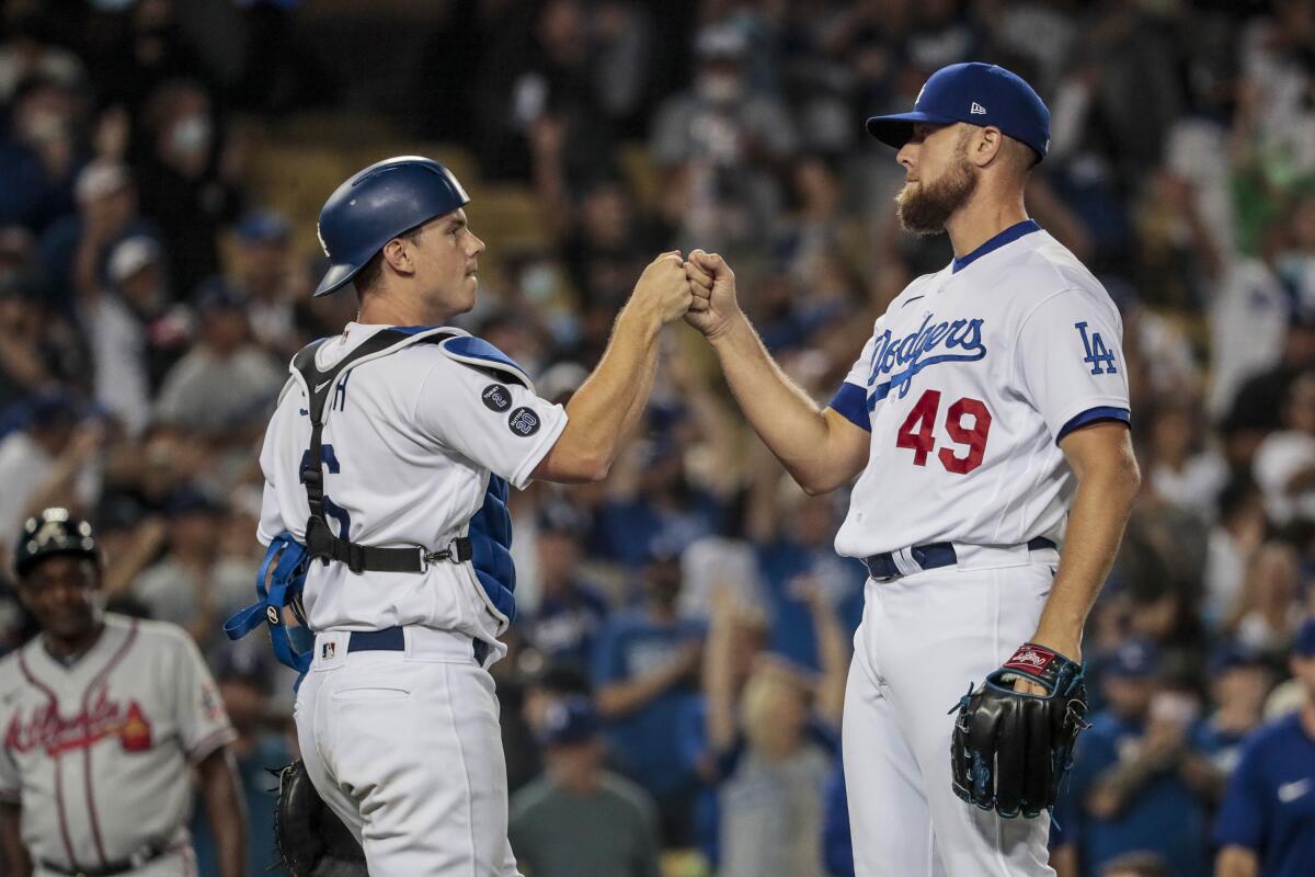 Blake Treinen (49) celebrates with Will Smith after the Dodgers' 5-3 victory over the Braves on Aug. 30.