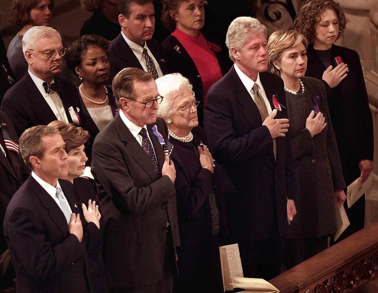From left: George W. Bush, Laura Bush, George H.W. Bush, Barbara Bush, Bill Clinton, Hillary Clinton and Chelsea Clinton during the presentation of the colors at the National Day of Prayer and Remembrance Service in 2001 at the National Cathedral in Washington.