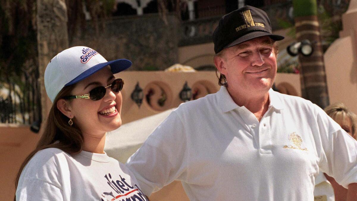 Miss Universe Alicia Machado, left, and Donald Trump chat at his Mar-a-Lago club in Palm Beach, Fla., on Feb. 15, 1997.