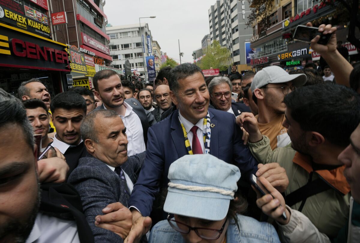 FILE - Sinan Ogan, center, the nationalist presidential candidate, is surrounded by supporters during a city tour, in Ankara, Turkey, on May 4, 2023. The third-placed contender in the Turkish presidential elections on Monday May 22, 2023 formally endorsed President Recep Tayyip Erdogan for the second-round runoff vote to be held on May 28th. Ogan, 55, has emerged as a potential kingmaker after neither Erdogan nor his main challenger, opposition leader Kemal Kilicdaroglu, secured the majority needed for a first-round victory on May 14th. (AP Photo/Burhan Ozbilici, File)