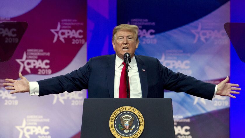 Then-President Trump holds out his arms at the Conservative Political Action Conference in March  2019. 