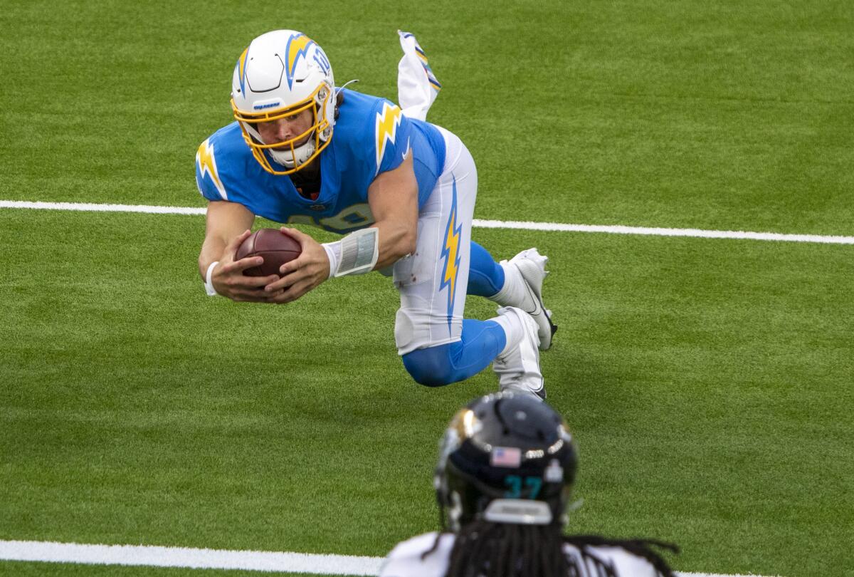 Chargers quarterback Justin Herbert dives to complete a touchdown run
