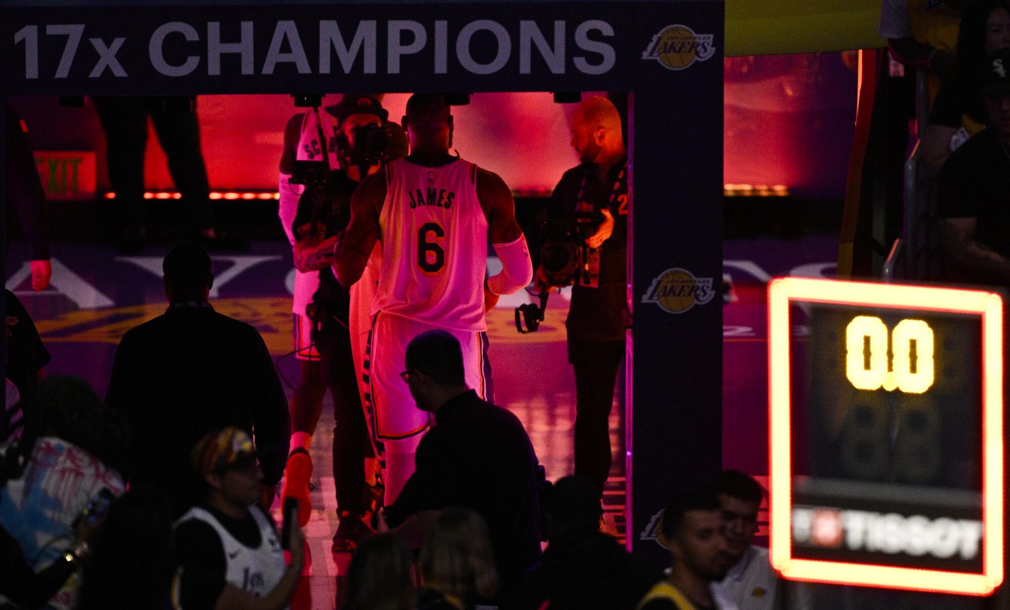Lakers forward LeBron James walks away from the court after losing to the Denver Nuggets in Game 3.