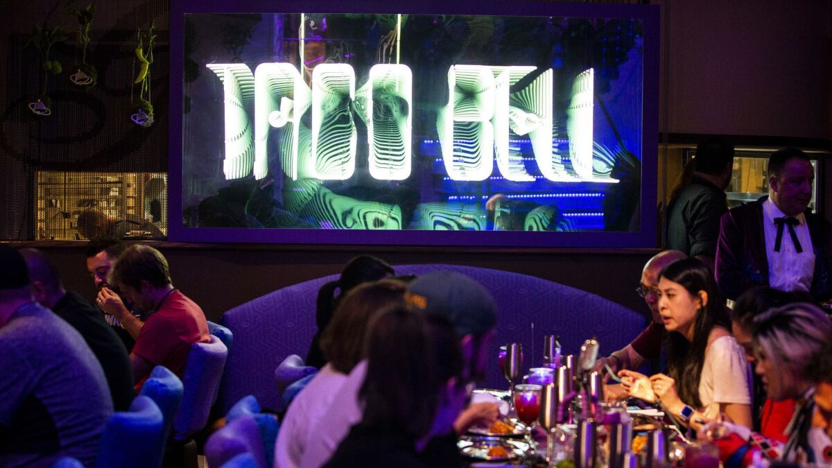 A futuristic Taco Bell sign hangs in the dining room at the Demolition Man Taco Bell 2023 activation during the first day of the 2018 San Diego Comic-Con International.