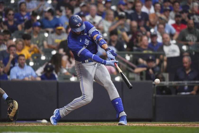 Toronto Blue Jays' Lourdes Gurriel Jr. hits a single during the fourth inning of the team's baseball game against the Milwaukee Brewers Friday, June 24, 2022, in Milwaukee. (AP Photo/Kenny Yoo)
