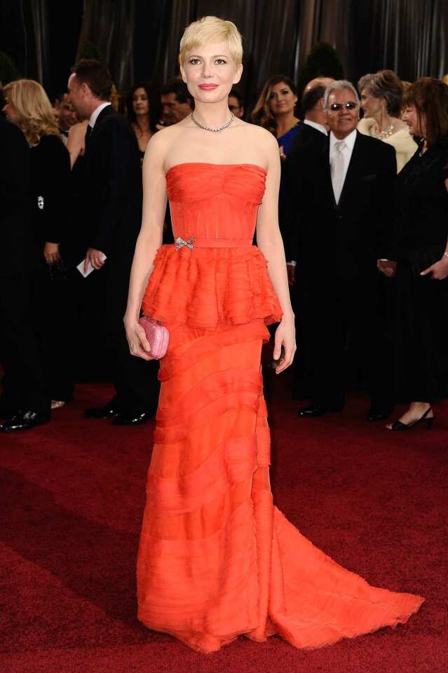 Michelle Williams' burnt-orange, silk-ribbon Louis Vuitton gown was flirty, feminine and reminiscent of the 1950s.