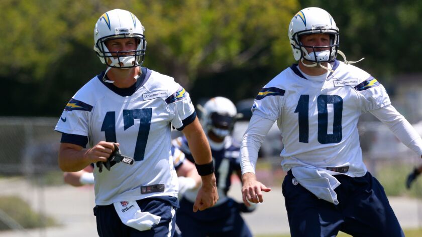 Chargers quarterbacks Philip Rivers (17) and Kellen Clemens stretch before a workout.