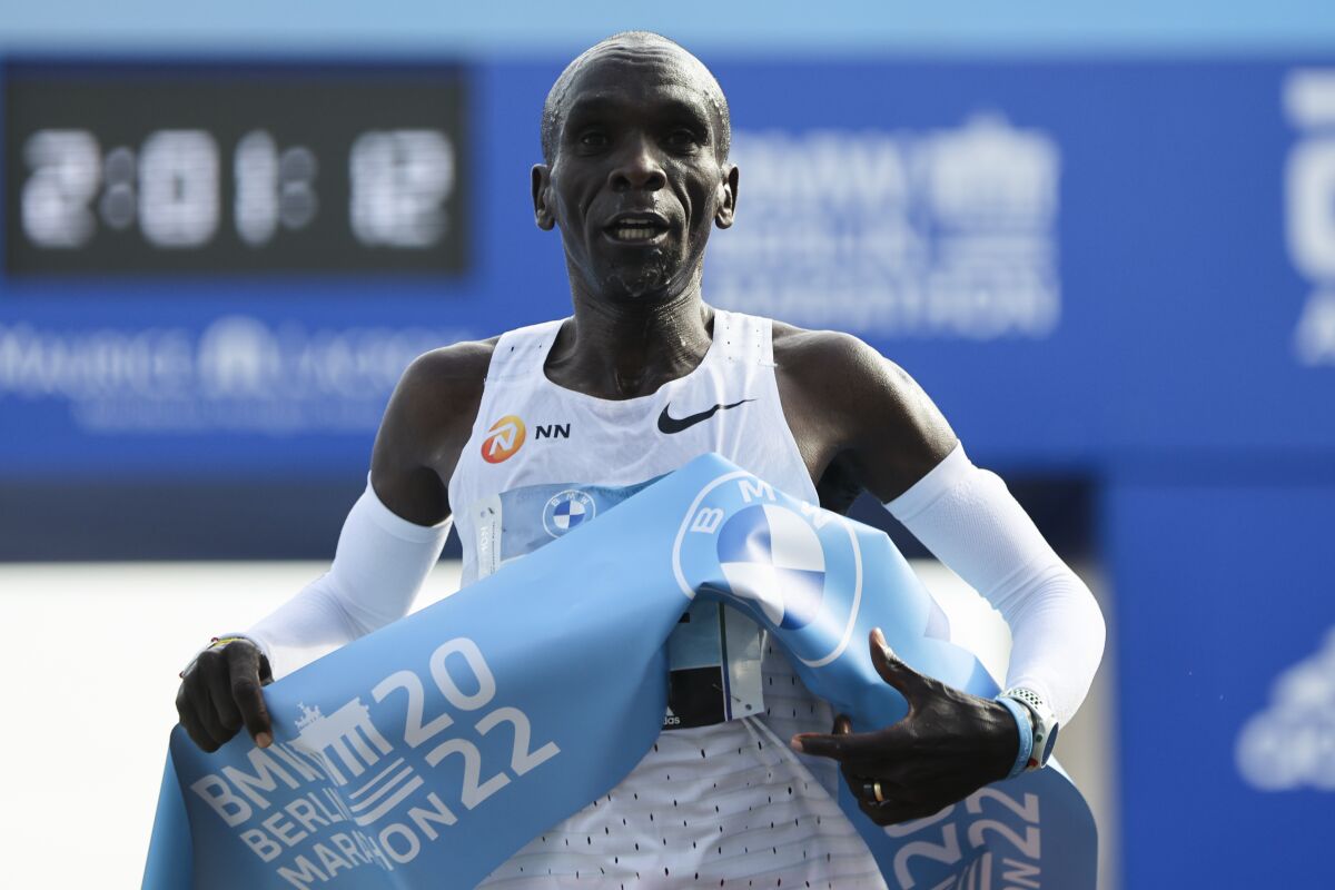 FILE - Kenya's Eliud Kipchoge crosses the line to win the Berlin Marathon in Berlin on Sept. 25, 2022. Kipchoge will make his Boston Marathon debut in 2023 along with reigning women’s world champion Gotytom Gebreslase and six former Boston winners returning 10 years after two bombs exploded at the finish line.(AP Photo/Christoph Soeder, File)