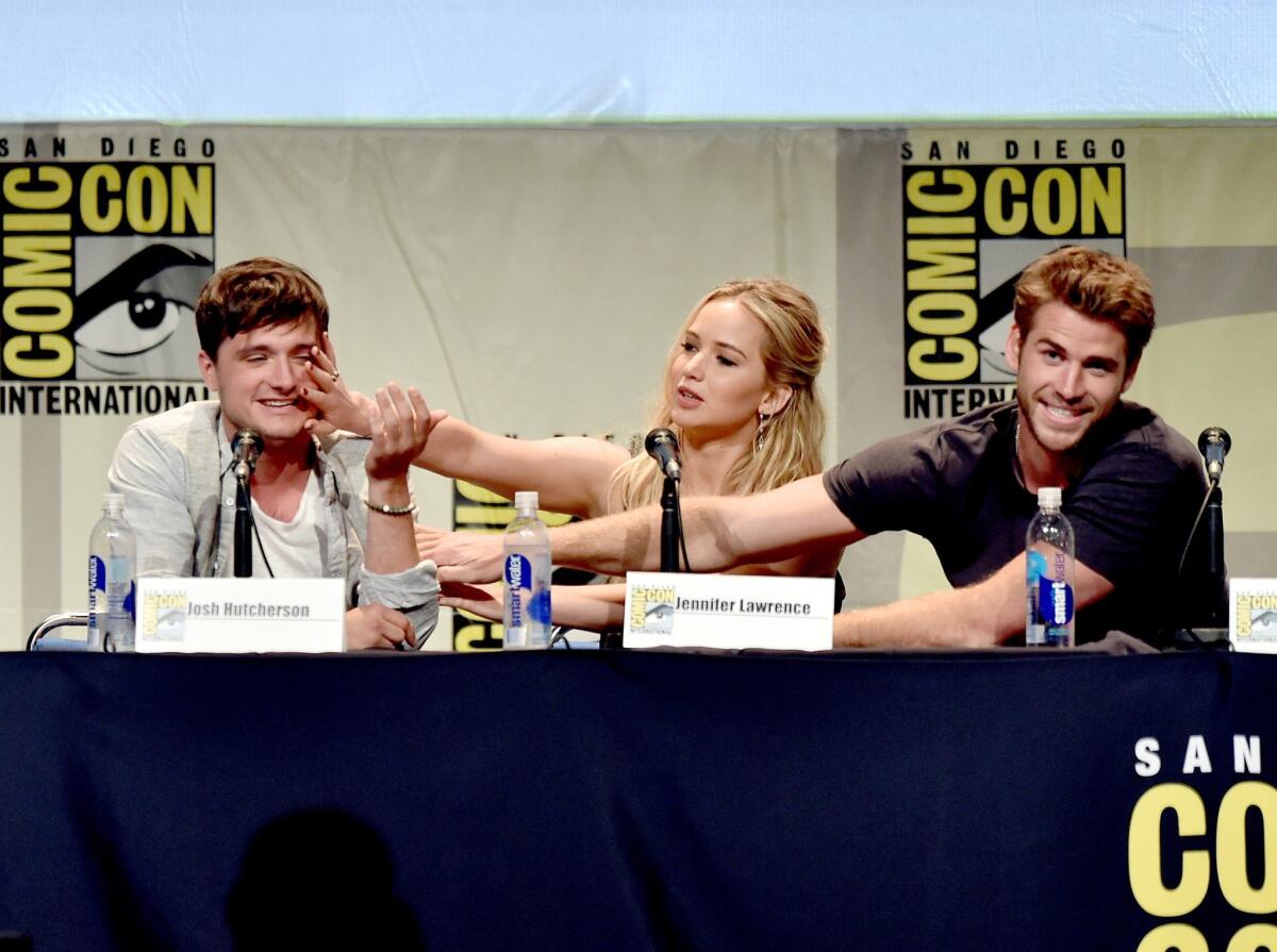 Actors Josh Hutcherson, Jennifer Lawrence and Liam Hemsworth speak at the "The Hunger Games: Mockingjay Part 2" panel during Comic-Con International 2015 at the San Diego Convention Center.