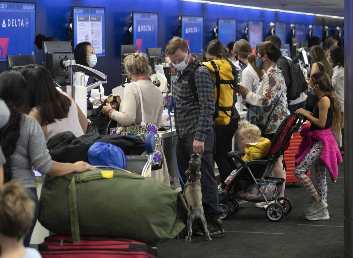 Air travelers prepare for a last dash of summer travel amid a surge in coronavirus cases.