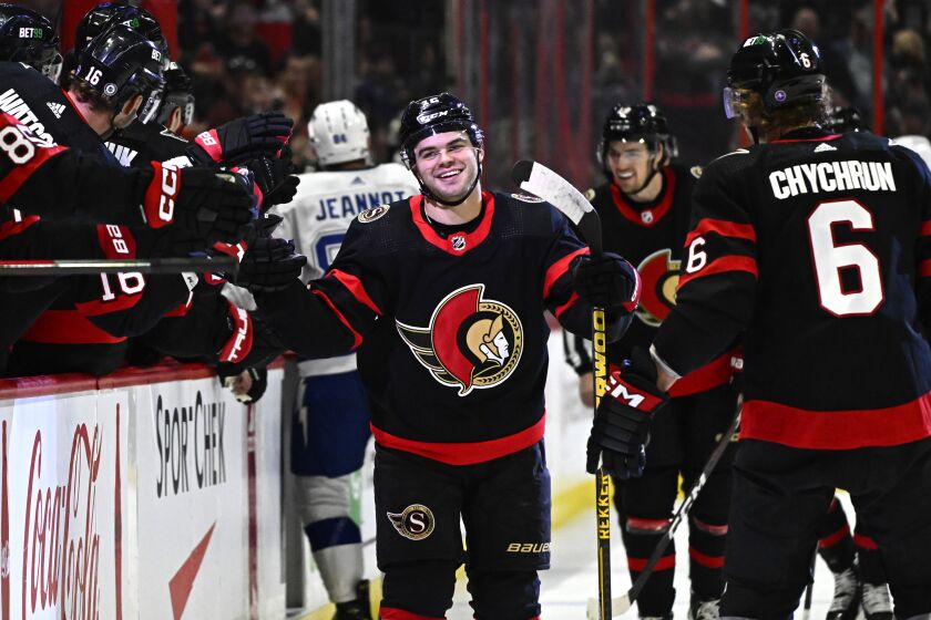Ottawa Senators right wing Alex DeBrincat (12) celebrates after his second goal against the Tampa Bay Lightning with teammates during first-period NHL hockey game action in Ottawa, Thursday, March 23, 2023. (Justin Tang/The Canadian Press via AP)