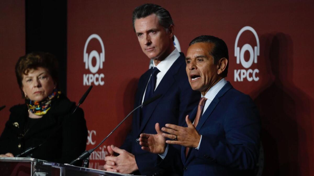 Delaine Eastin, left, Lt. Gov. Gavin Newsom listen as former L.A. Mayor Antonio Villaraigosa speaks during a gubernatorial debate Saturday.
