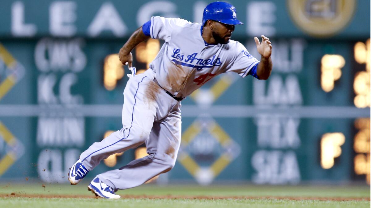 Second baseman Howie Kendrick strained his left hamstring during the Dodgers' game against the Pirates on Sunday in Pittsburgh.