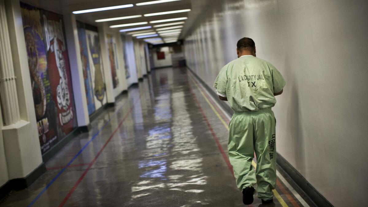 An inmate walks a hallway in Men's Central.