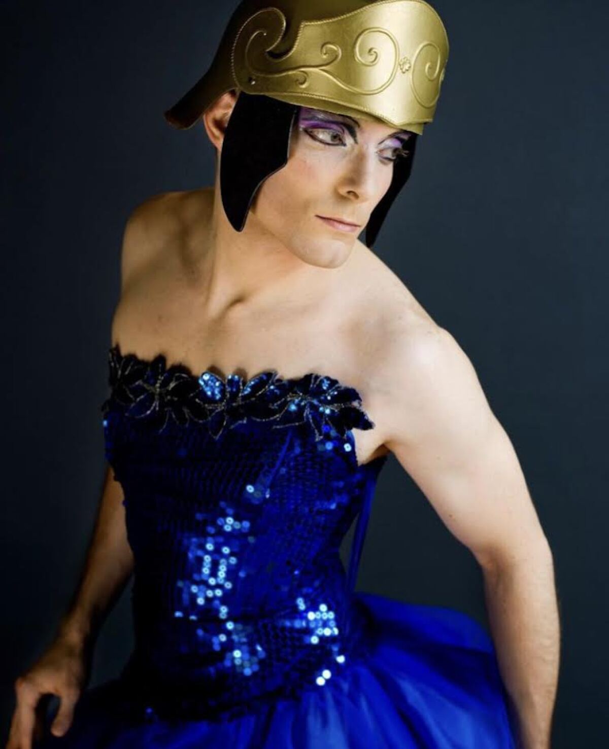 A person in a crown and blue outfit.