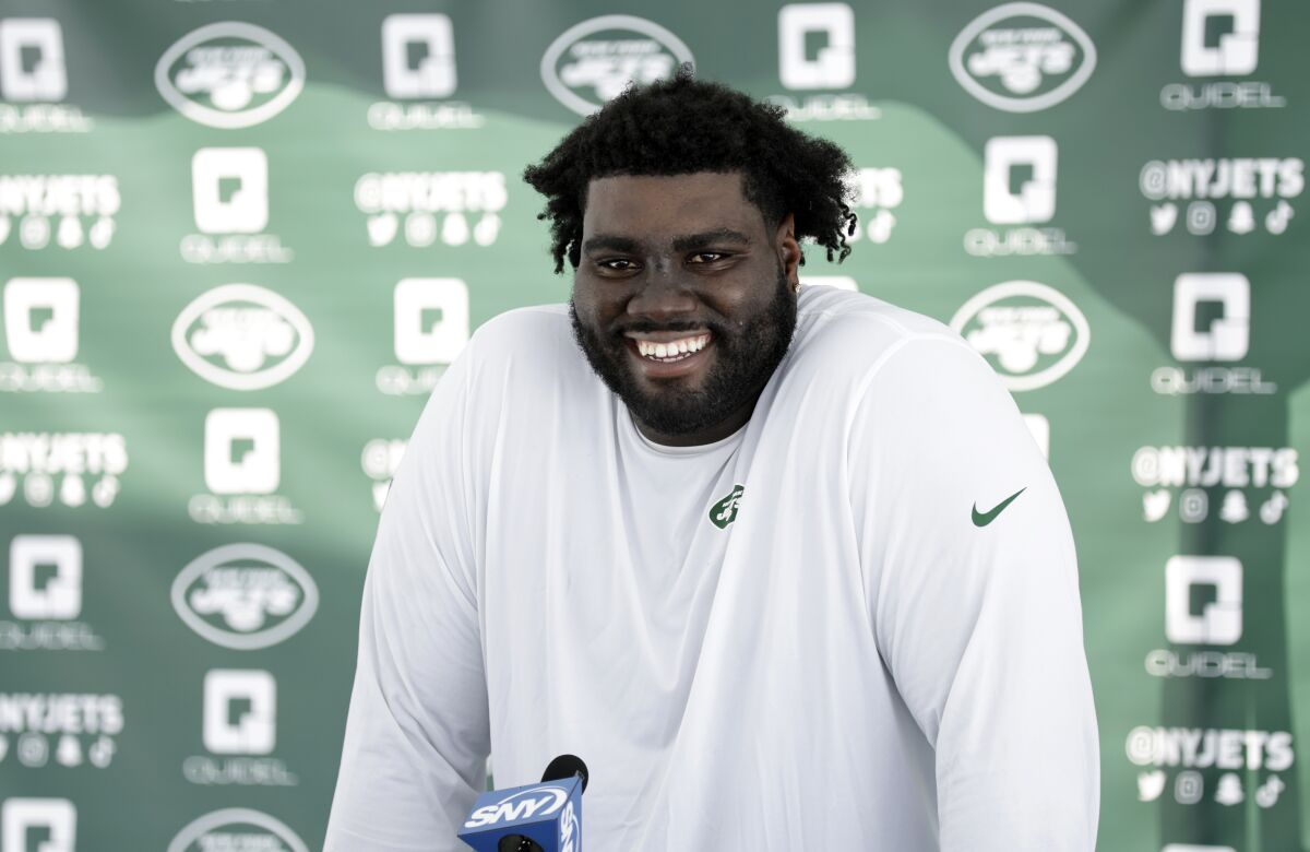 New York Jets tackle Mekhi Becton speaks to the media at the NFL football team's practice facility in Florham Park, N.J., Wednesday, July 27, 2022. (AP Photo/Adam Hunger)