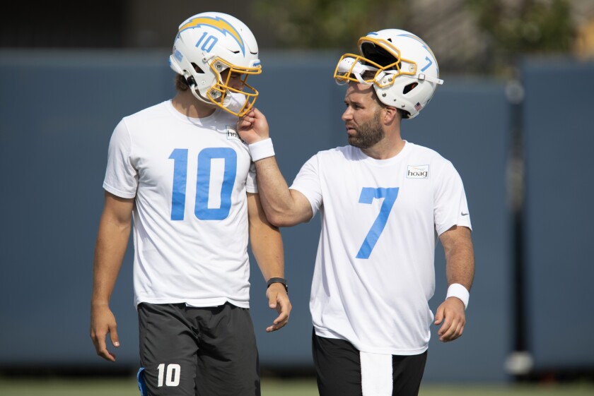 Chargers quarterbacks Chase Daniel, right, and Justin Herbert on the field during camp.