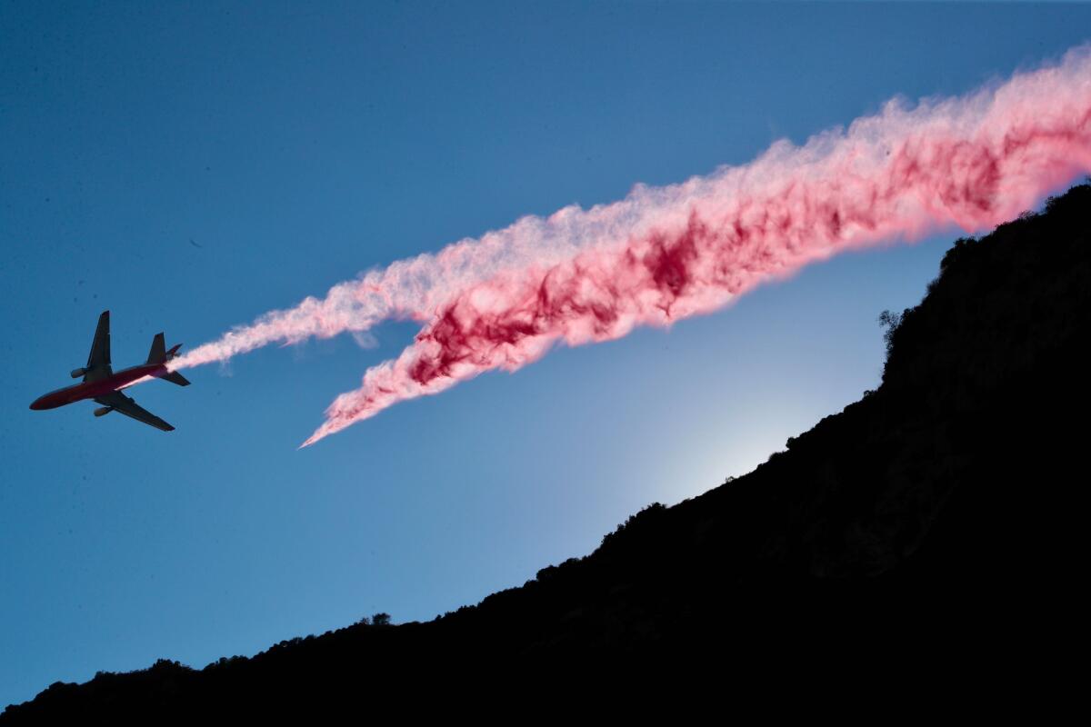 An aerial assault begins on the Dam fire Thursday afternoon.