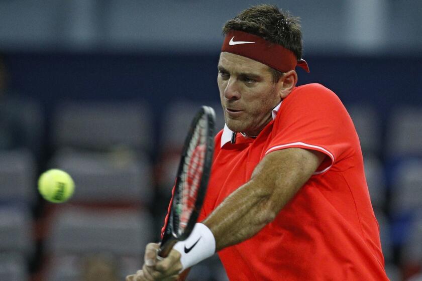 Juan Martin Del Potro of Argentina hits a return shot to Borna Coric of Croatia during their men's singles match of the Shanghai Masters tennis tournament at Qizhong Forest Sports City Tennis Center in Shanghai, China, Thursday, Oct. 11, 2018. (AP Photo/Andy Wong)