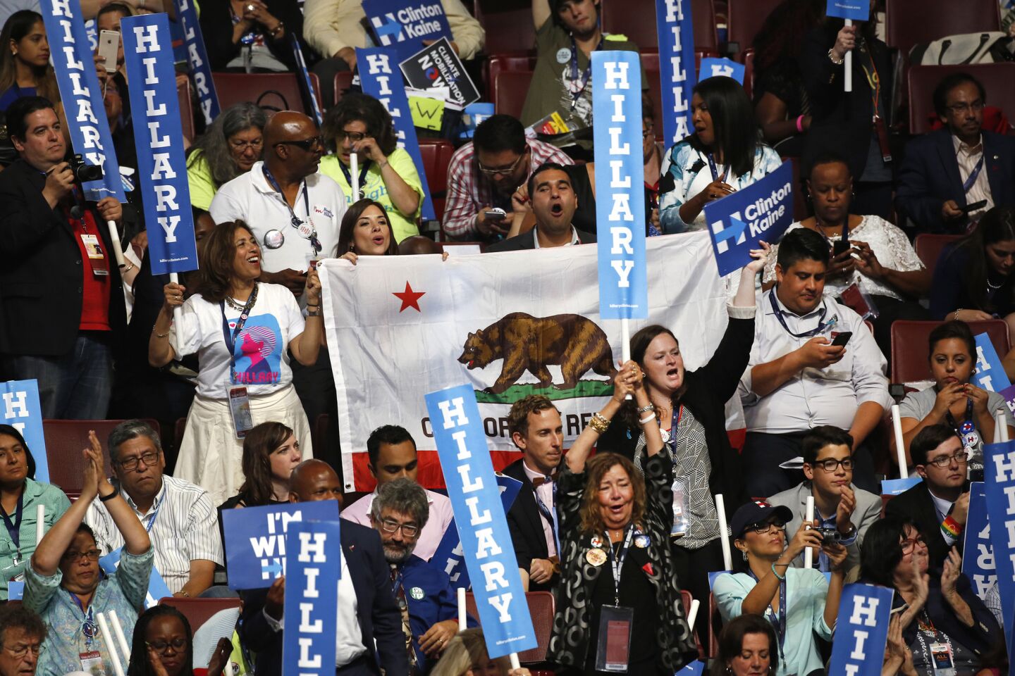 Members of the California delegation cheer for Representative Nancy Pelosi as she speaks on the final night of the Democratic National Convention in Philadelphia.