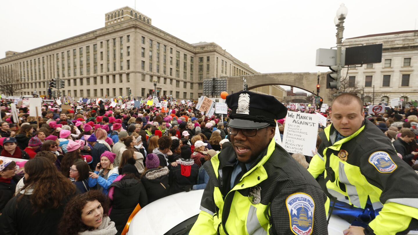 Police keep watch on thousands gathered Saturday in Washington to march for women's rights.