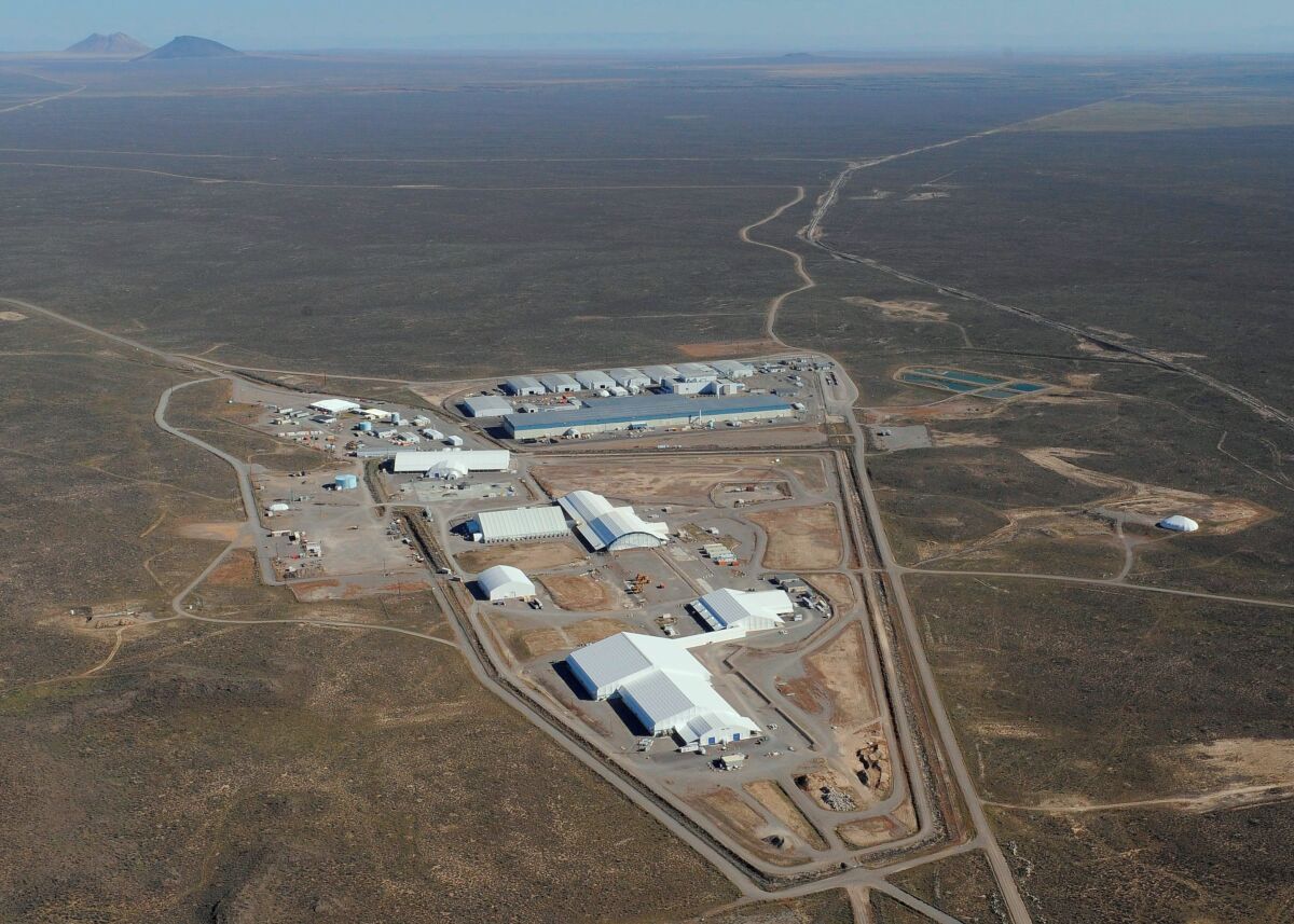 This 2014 aerial photo provided by Idaho Environmental Coalition shows the U.S. Department of Energy's 890-square-mile Radioactive Waste Management Complex site in eastern Idaho. The complex includes the Accelerated Retrieval Project facilities in the foreground and the Advanced Mixed Waste Treatment Project in the background. U.S. officials say they have almost completed a roughly 20-year project to dig up and remove radioactive and hazardous waste buried for decades in unlined pits at a nuclear facility that sits atop a giant aquifer in Idaho Falls in eastern Idaho. (Idaho Environmental Coalition/U.S. Department of Energy via AP)