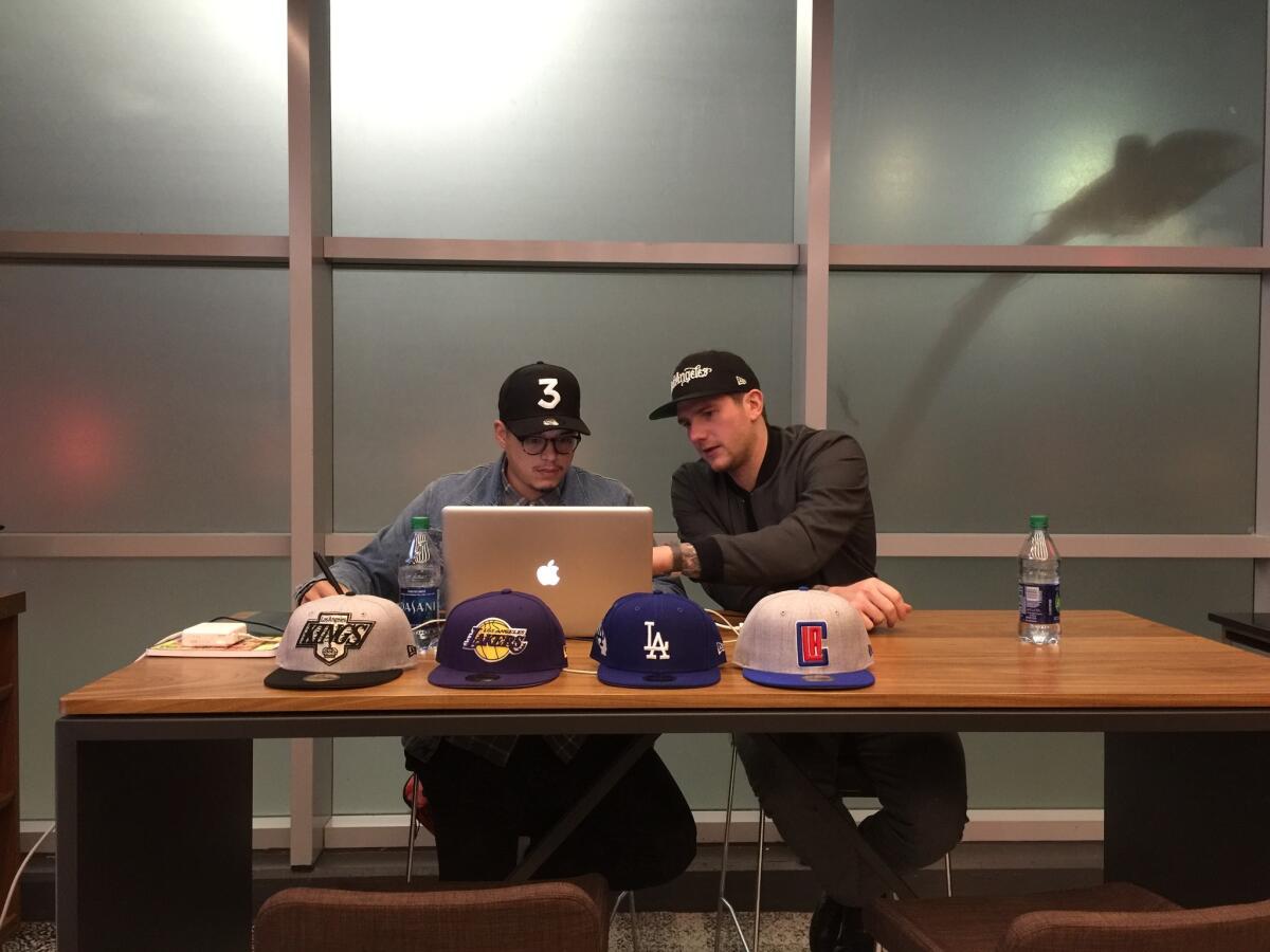 Jonathan Quick, right, designs his own cap at NHL All-Star Game Fan Fest at Staples Center on Jan. 26.