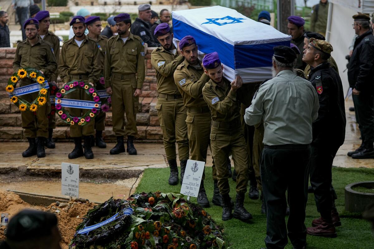 Israeli soldiers carry the flag-draped casket of Staff Sgt. Birhanu Kassie during his funeral.