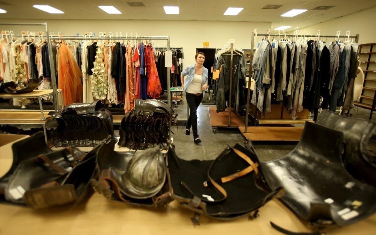 The L.A. Opera's costume shop, pictured in 2013 during the tailoring of outfits for "The Magic Flute," is moving -- so an estimated 1,000 costumes are being put up for sale.