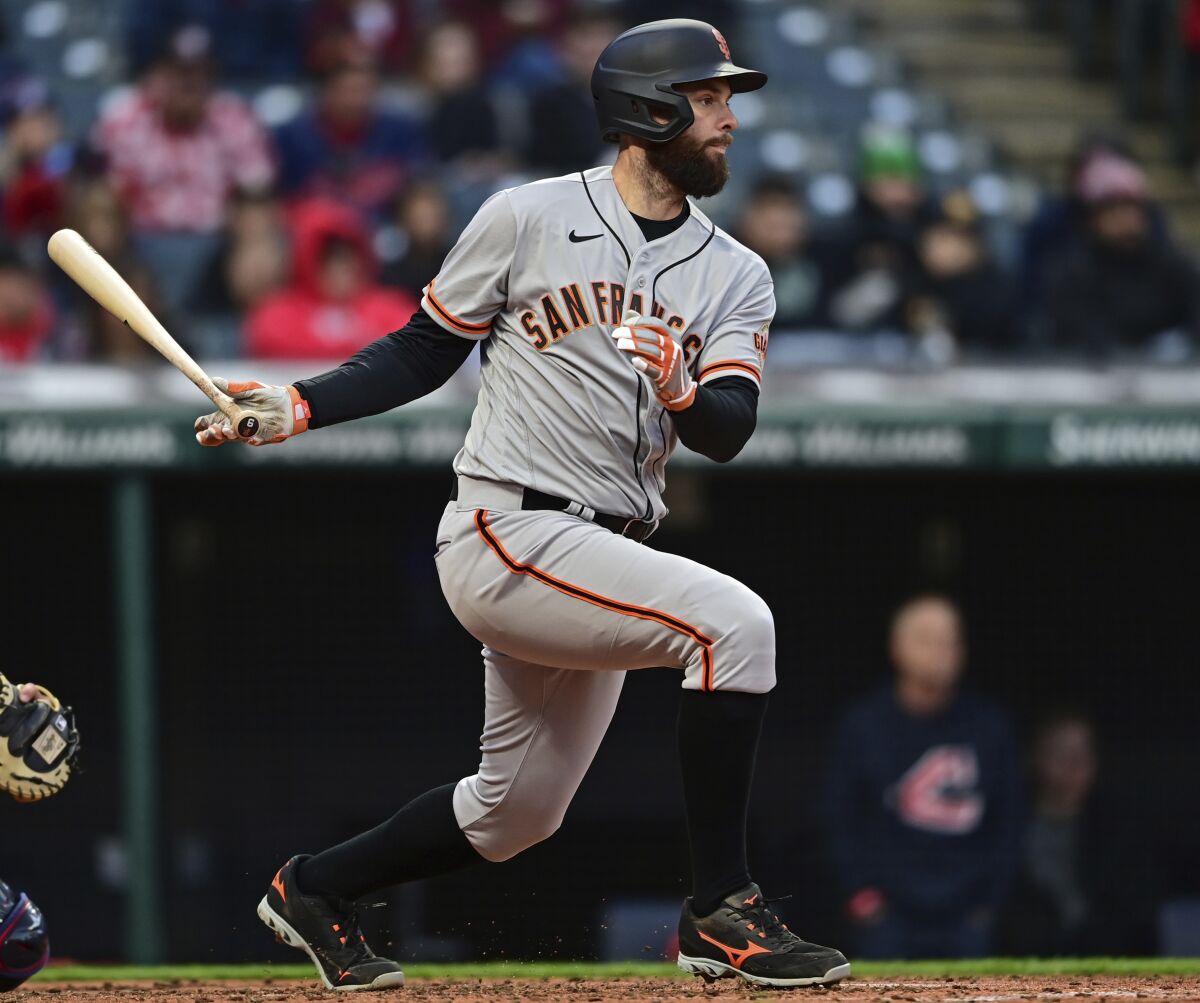 San Francisco Giants Brandon Belt watches the ball after hitting a two-RBI single in the fifth inning of a baseball game against the Cleveland Guardians, Saturday, April 16, 2022, in Cleveland. (AP Photo/David Dermer)