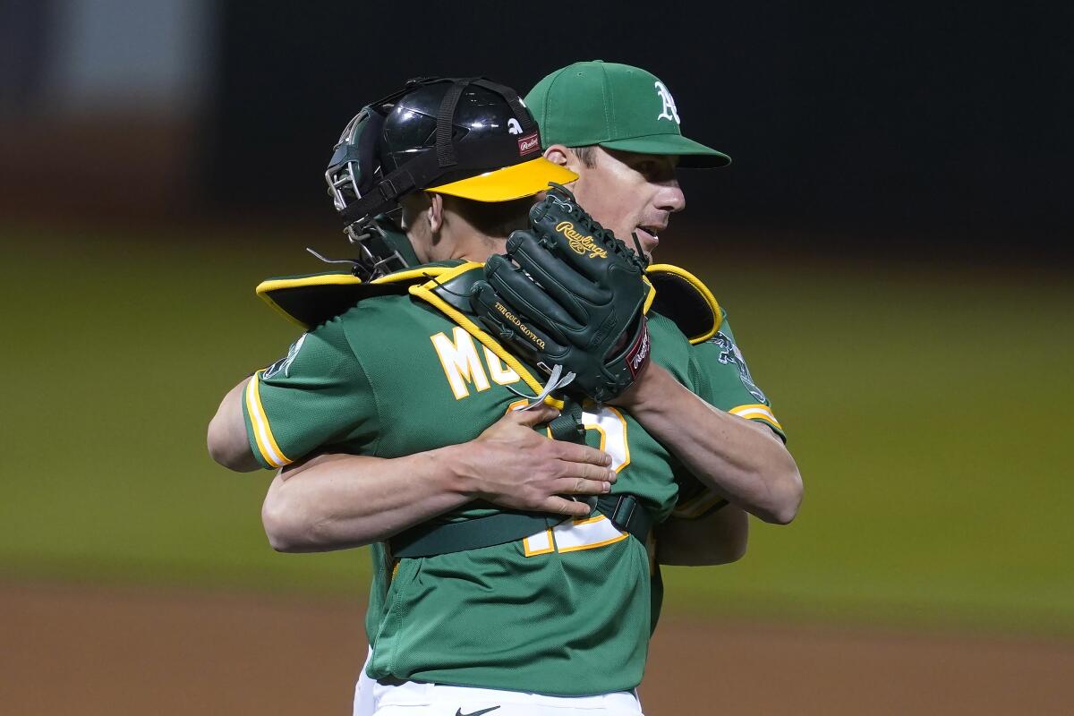 Oakland Athletics catcher Sean Murphy celebrates with pitcher Chris Bassitt after a 5-0 win over the Angels on Thursday.