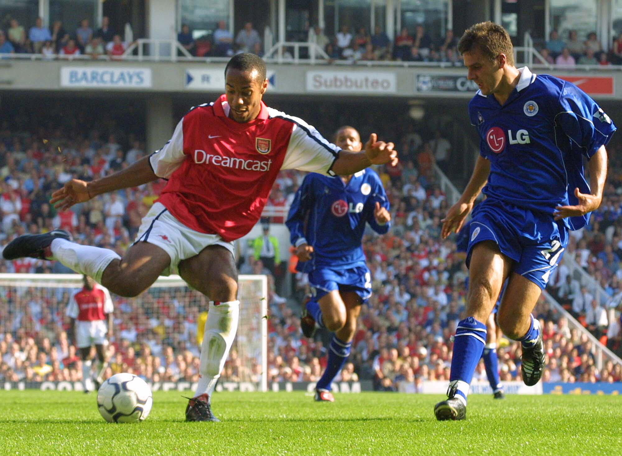 In 2001, Arsenal's Thierry Henry is shown fending off a challenge by a Leicester City player 