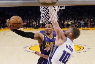 Los Angeles Lakers guard Russell Westbrook, left, shoots as Sacramento Kings forward Domantas Sabonis defends during the second half of an NBA basketball game Friday, Nov. 11, 2022, in Los Angeles. (AP Photo/Mark J. Terrill)