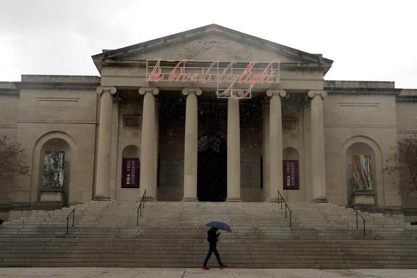A man walks past the Baltimore Museum of Art on a rainy day