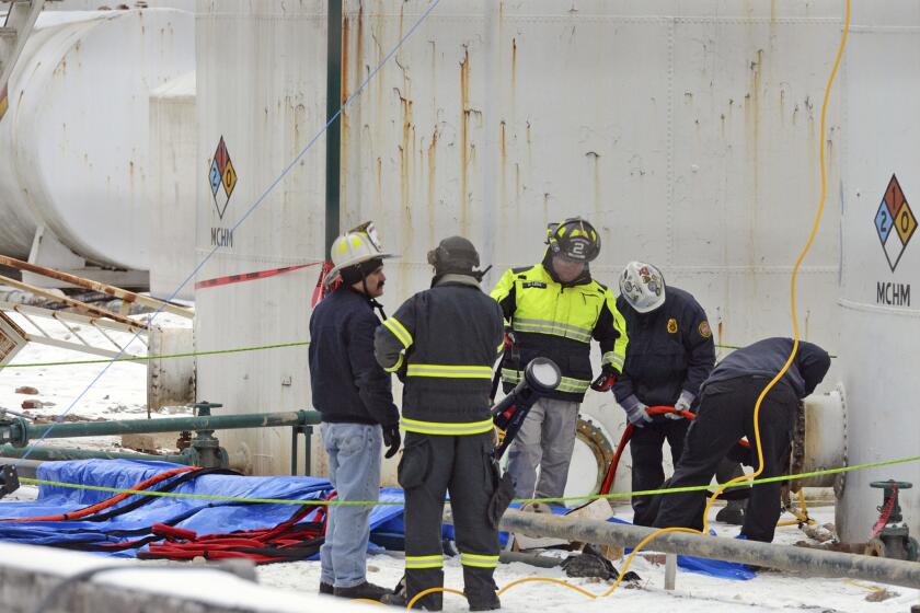 Investigators with the FBI and local fire departments inspect the Freedom Industries site in West Virginia in January.