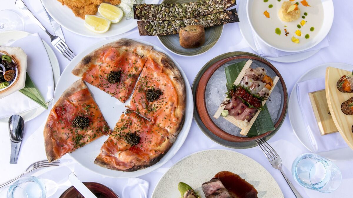 A spead at Spago, Wolfgang Puck's flagship restaurant in Beverly Hills, may include (clockwise from top left) veal Wiener schnitzel; bread plate; corn soup; spicy tuna tartare cones; Chirashi box; A-5 Wagyu steak; pizza with house-cured smoked salmon; and Spanish octopus.