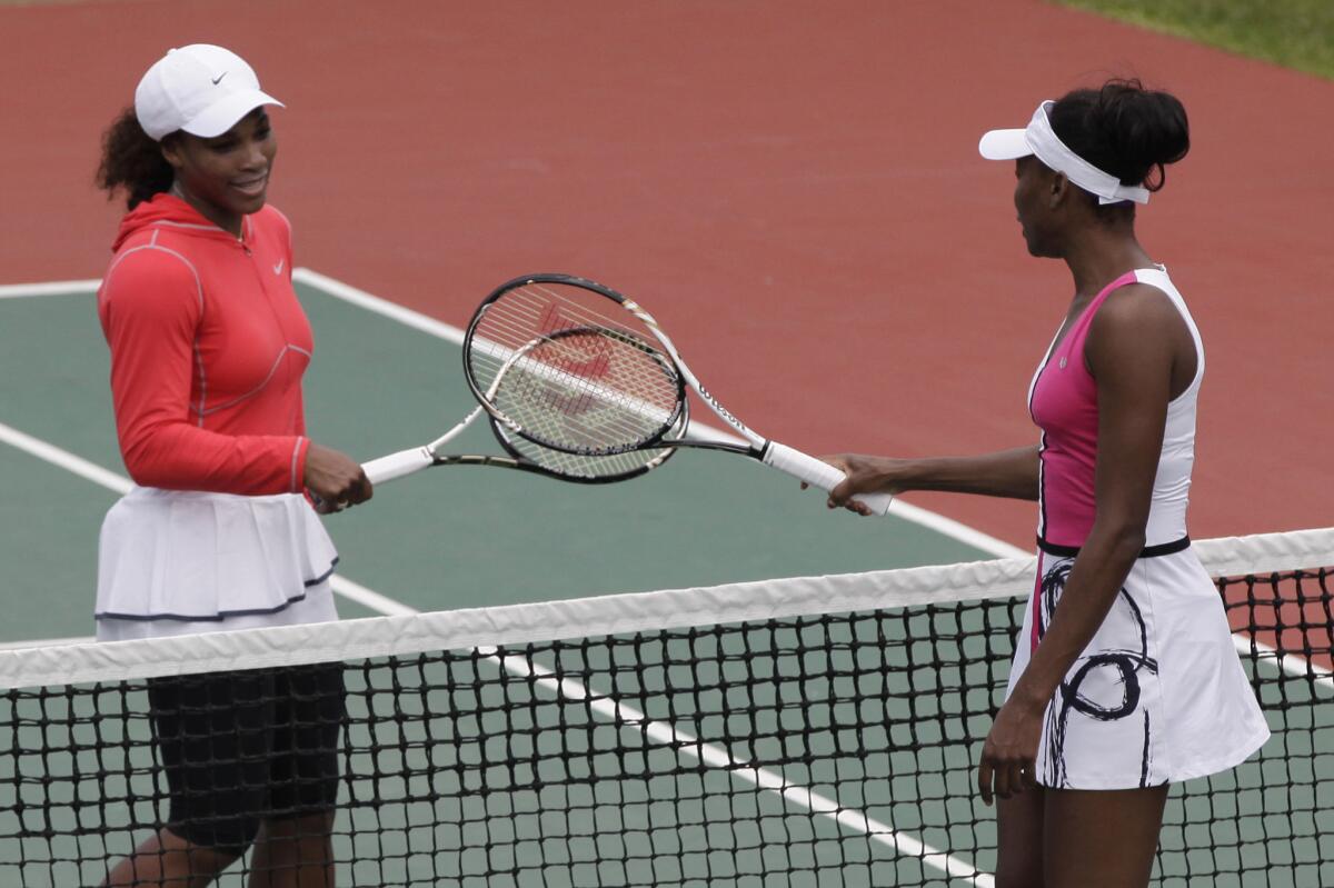 Serena Williams, left, and Venus Williams before an exhibition match in Lagos, Nigeria, in 2012.